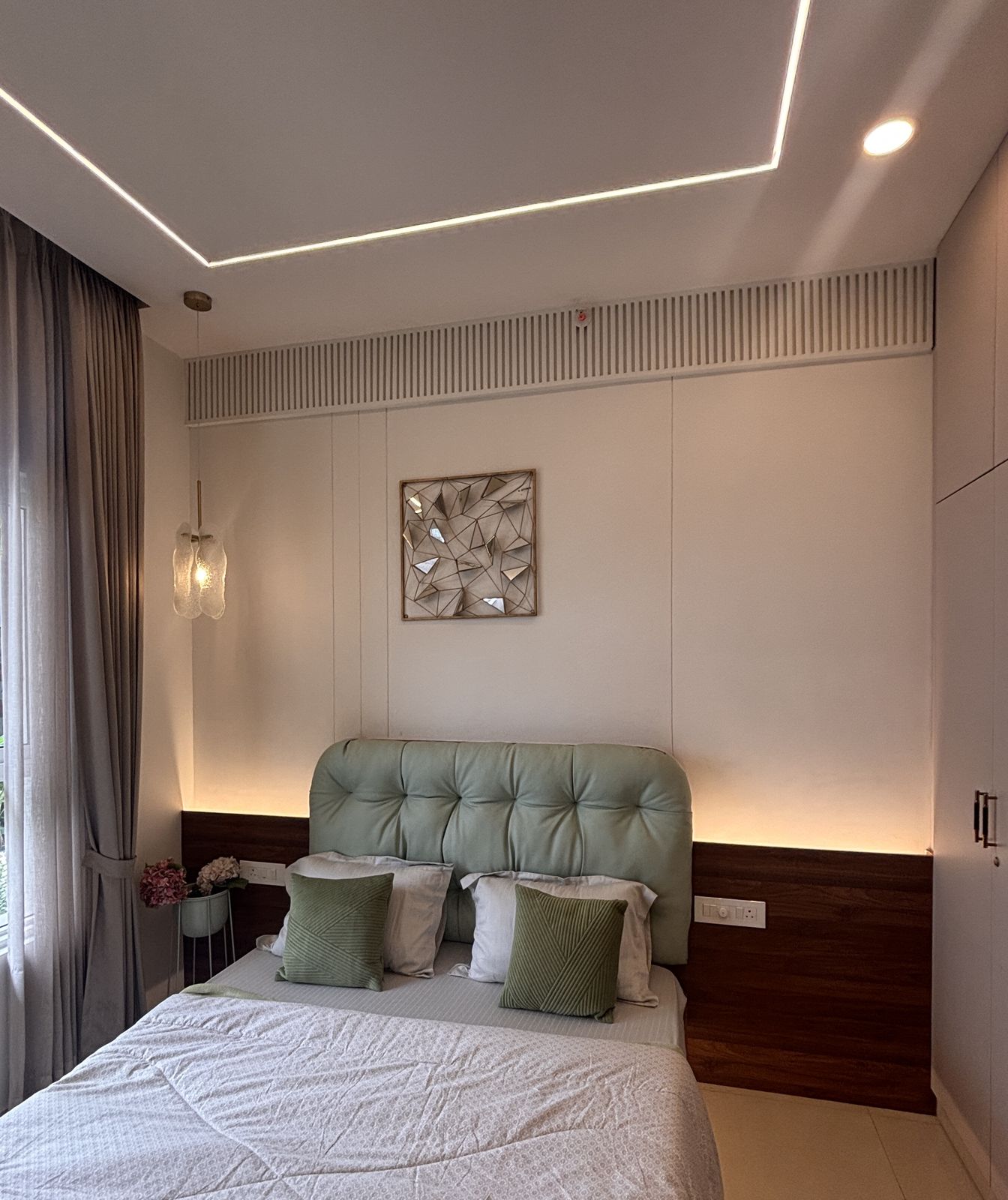Bedroom with tufted green headboard, Wood & Co. Interiors