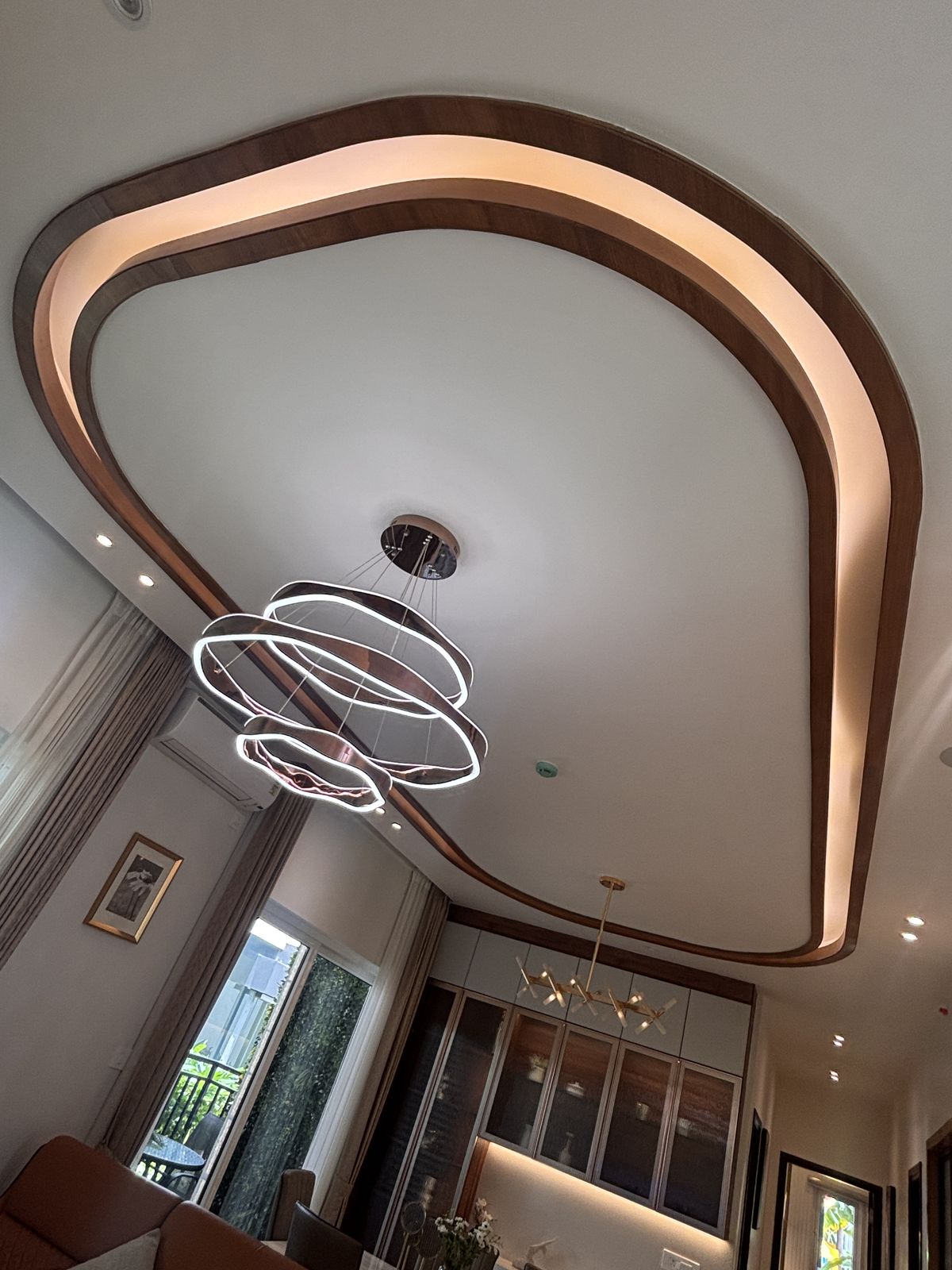 Curved false ceiling with statement chandelier, Wood & Co. Interiors